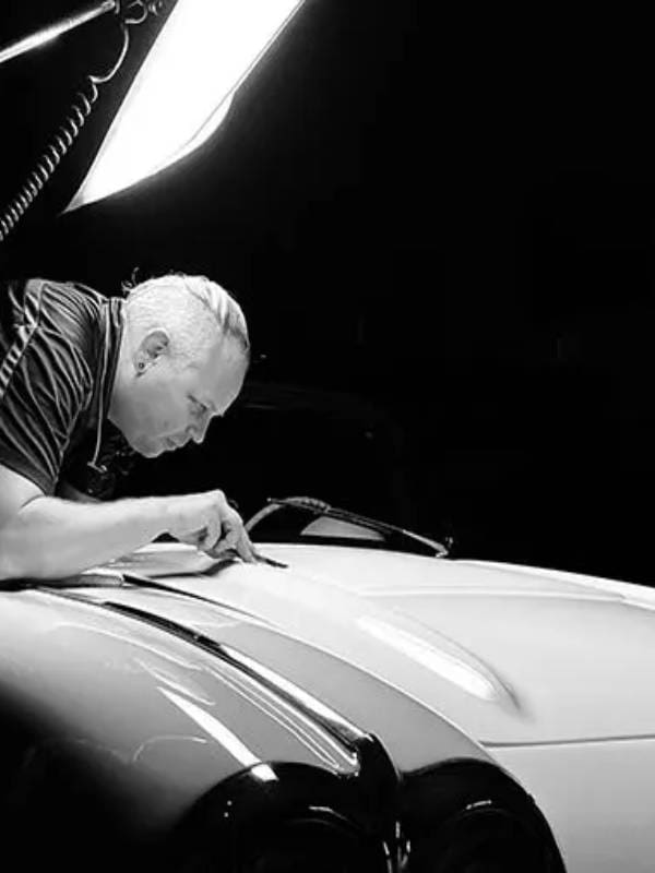 Man detailing a vintage car.