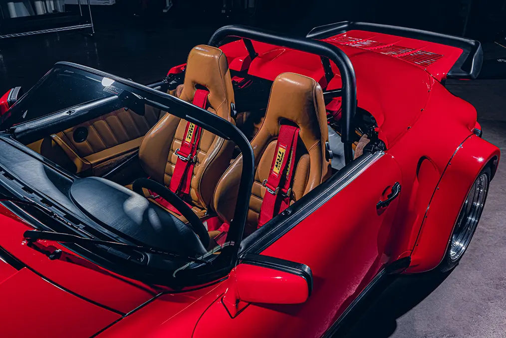 Red Porsche 911 with roll cage.