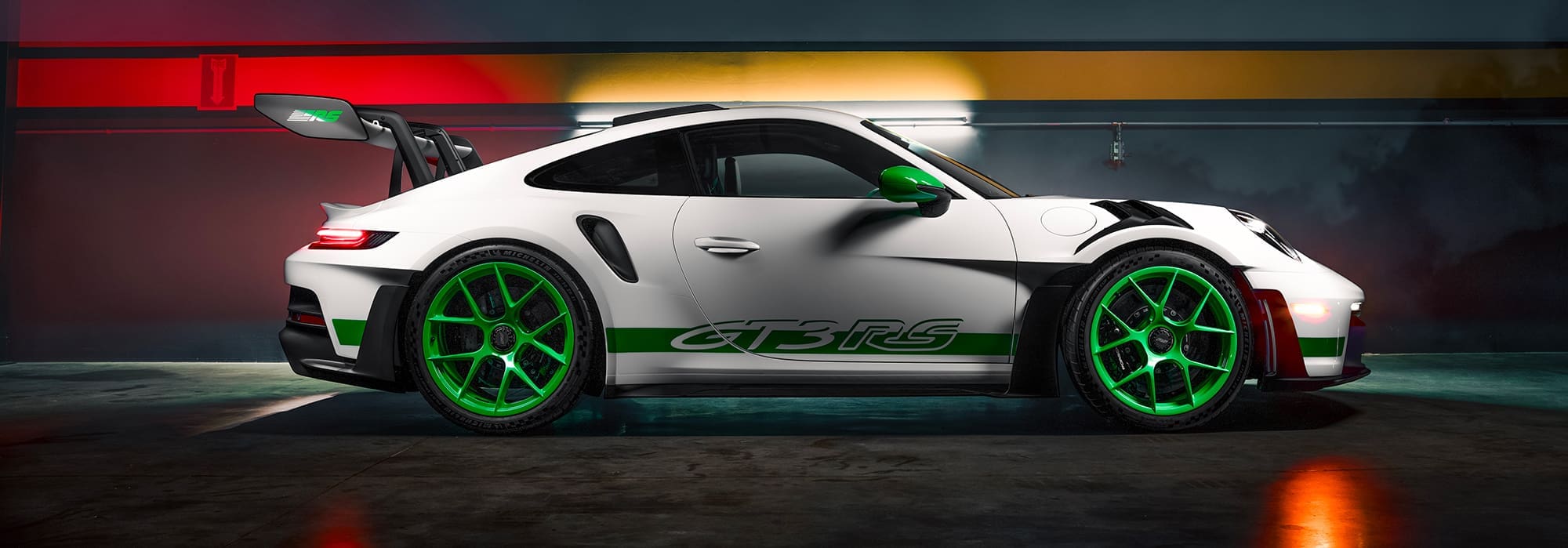 White Porsche GT3 RS with green wheels.