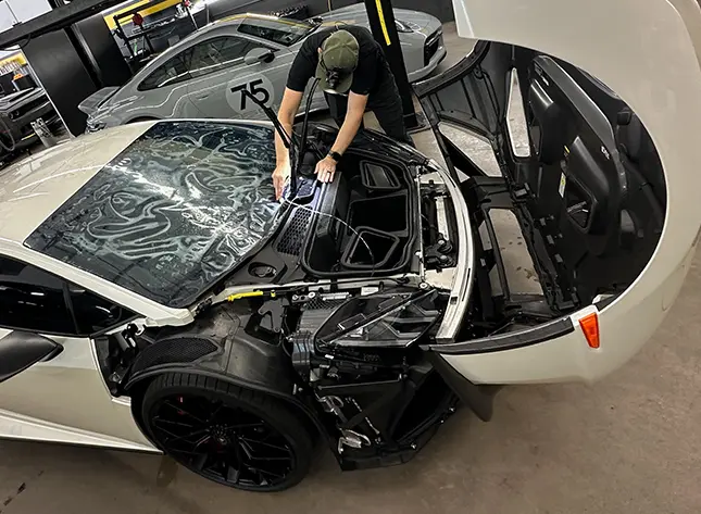 White Lamborghini with hood open.