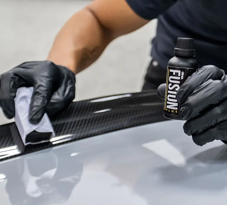 Person applying car detailing product.