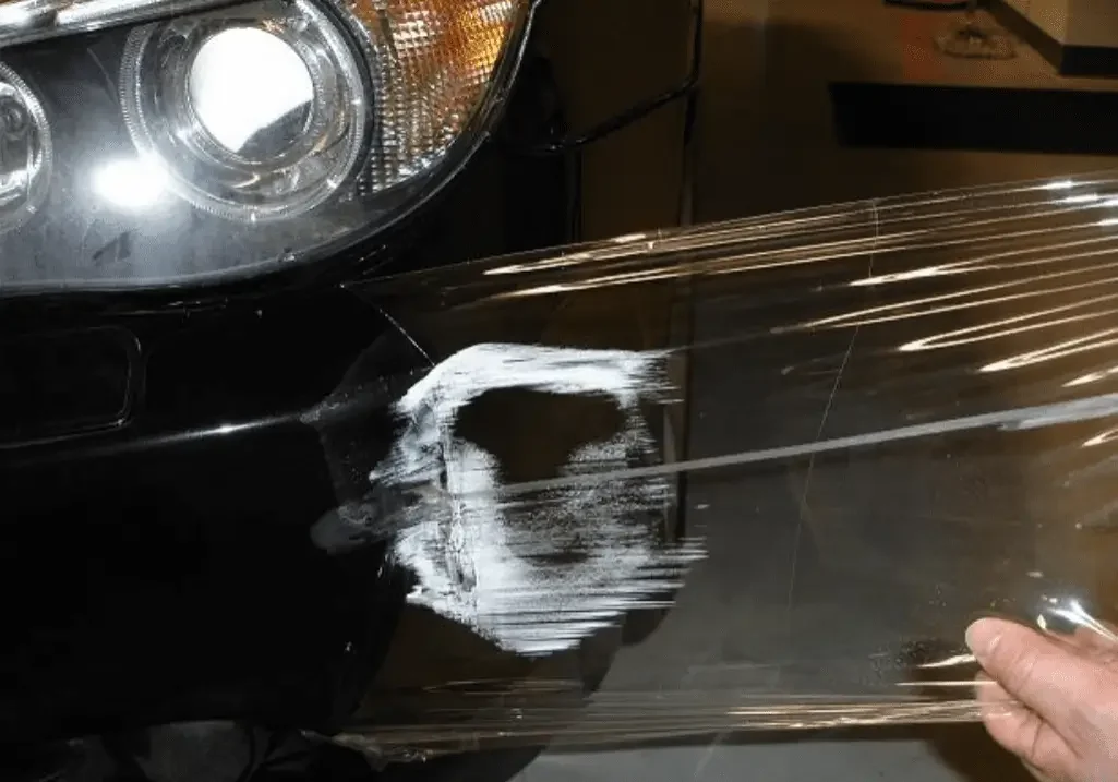 White paint on a black car bumper.